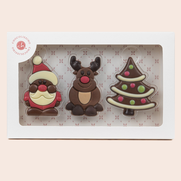 Świąteczne trio z czekokady. Mikołaj, renifer i choinka wyglądają przez okienko w białym opakowaniu.